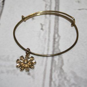 Beautiful gold bangle bracelet with flower charm